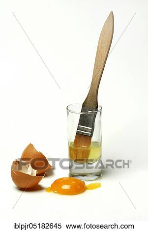 Stock Photography - Egg white in glass, egg yolk, egg shells, egg white, egg, egg shell, hen's egg, hen's eggs, brush. Fotosearch