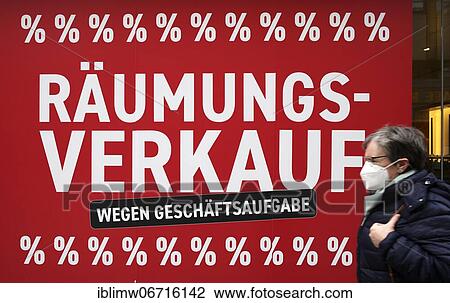 Stock Image - Elderly woman with mouth mask, clearance sale due to closure of business, discount battle in shop window, SALE, price reductions, fashion store Breitling, Stuttgart, Baden-Württemberg, Germany, Europe. Fotosearch
