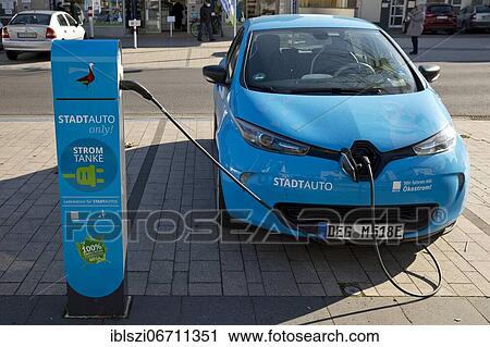 Electric car charging as city car for rent, Monheim am Rhein, North Rhine-Westphalia, Germany, Europe View Large Photo Image Stock Image - Electric car charging as city car for rent, Monheim am Rhein, North Rhine-Westphalia, Germany, Europe. Fotosearch