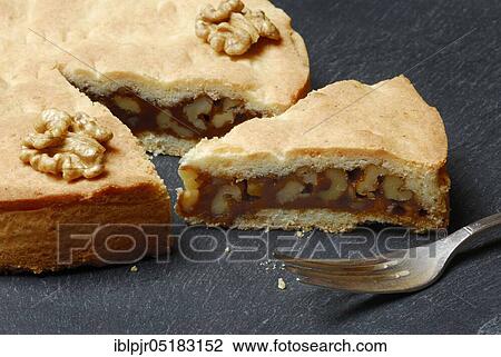 Stock Image - Engadine nut cake, cake, walnut, short pastry with caramel and walnuts, fork. Fotosearch