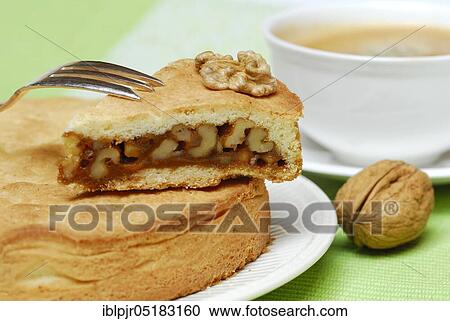 Stock Image - Engadine nut cake, cake, walnut, short pastry with caramel and walnuts, fork, plate, cake plate. Fotosearch