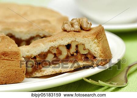 Stock Photo - Engadine nut cake, cake, walnut, short pastry with caramel and walnuts, fork, plate, cake plate. Fotosearch