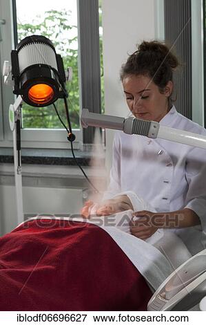 Facial compress in combination with the steamer and a Hydrosun coloured light therapy in practical lessons. Training as a beautician at the vocational school, Düsseldorf, North Rhine-Westphalia, Germany, Europe View Large Photo Image Stock Photo - Facial compress in combination with the steamer and a Hydrosun coloured light therapy in practical lessons. Training as a beautician at the vocational school, Düsseldorf, North Rhine-Westphalia, Germany, Europe. Fotosearch