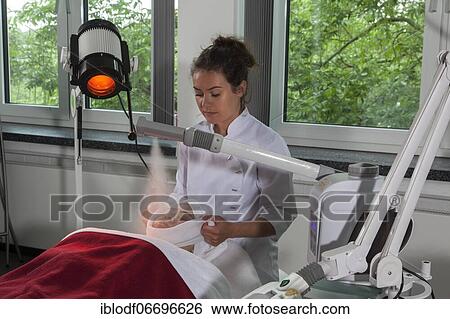 Facial compress in combination with the steamer and a Hydrosun coloured light therapy in practical lessons. Training as a beautician at the vocational school, Düsseldorf, North Rhine-Westphalia, Germany, Europe View Large Photo Image Stock Photograph - Facial compress in combination with the steamer and a Hydrosun coloured light therapy in practical lessons. Training as a beautician at the vocational school, Düsseldorf, North Rhine-Westphalia, Germany, Europe. Fotosearch