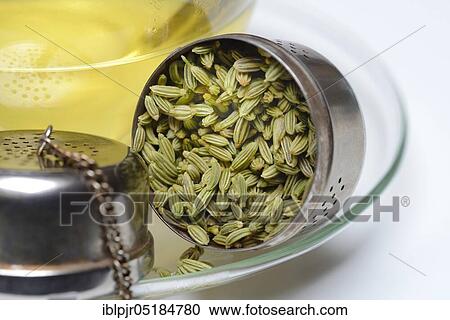 Stock Image - Fennel tea in cup and fennel seeds in spoon, fennel tea. Fotosearch
