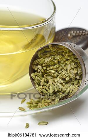 Stock Image - Fennel tea in cup and fennel seeds in spoon, fennel tea. Fotosearch