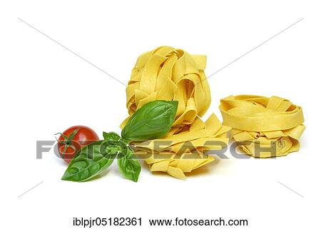 Stock Image - Fettucine dyed with saffron, with tomato and basil, noodles, pasta, ribbon noodles. Fotosearch