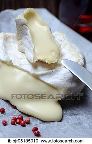 Stock Image - French soft cheese, Pave d'affinois, cut, sliced. Fotosearch