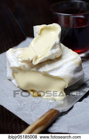 Stock Photo - French soft cheese, Pave d'affinois, cut, sliced. Fotosearch