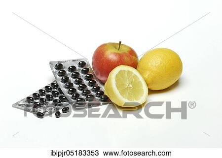 Stock Image - Fruit and food supplements, lemon, apple, dragées, deficient food. Fotosearch