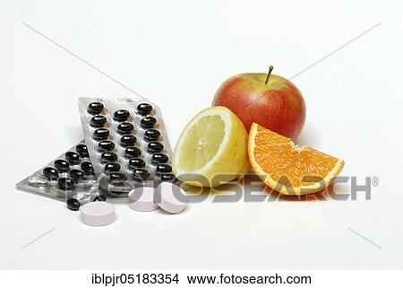 Picture - Fruit and food supplements, orange, lemon, apple, dragées, effervescent tablets, deficient food. Fotosearch