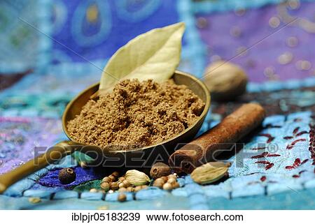 Stock Photo - Garam Masala, Indian spice powder, spice mix, spoon, ingredients cardamom, coriander, nutmeg, bay leaf, allspice, cinnamon. Fotosearch