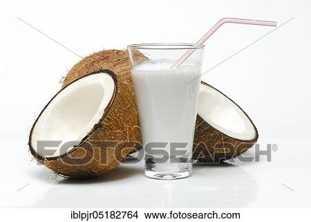 Glass of coconut milk, halved coconut, drinking straw, coconut milk View Large Photo Image Picture - Glass of coconut milk, halved coconut, drinking straw, coconut milk. Fotosearch