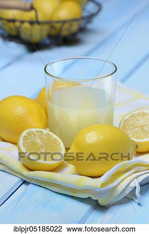 Glass of lemon juice with lemons View Large Photo Image Stock Image - Glass of lemon juice with lemons. Fotosearch