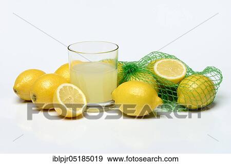 Stock Photo - Glass of lemon juice with lemons. Fotosearch