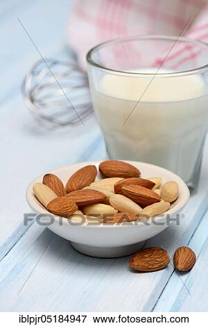 Glass of milk and bowl with almonds( Prunus dulcis), sweet almond View Large Photo Image Stock Photo - Glass of milk and bowl with almonds( Prunus dulcis), sweet almond. Fotosearch