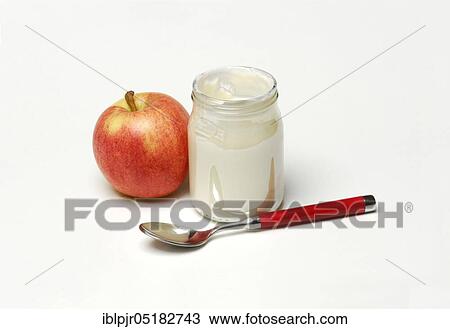 Stock Image - Glass of yoghurt and apple, natural yoghurt, dairy products. Fotosearch