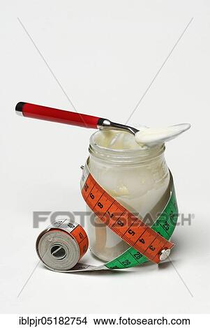 Glass of yoghurt and measuring tape, dairy products View Large Photo Image Picture - Glass of yoghurt and measuring tape, dairy products. Fotosearch