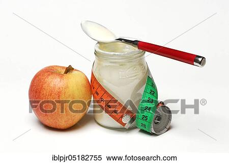 Glass of yoghurt, apple and tape measure, dairy products View Large Photo Image Stock Photography - Glass of yoghurt, apple and tape measure, dairy products. Fotosearch
