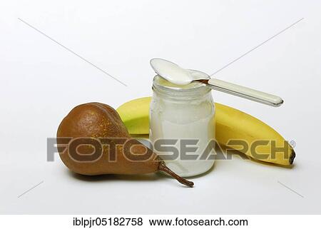 Stock Photo - Glass of yoghurt, pear and banana, dairy products, spoon. Fotosearch