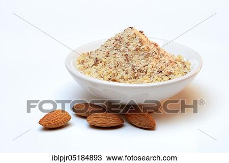 Stock Image - Ground almonds in shell and sweet almonds, almonds with skin ( Prunus dulcis). Fotosearch
