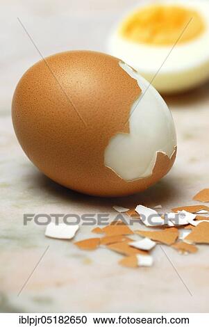 Stock Image - Hard boiled egg, partially peeled, hen's eggs, hen's egg, egg shell, eggshells, cooked. Fotosearch