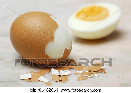 Stock Image - Hard boiled egg, partially peeled, hen's eggs, hen's egg, egg shell, eggshells, cooked. Fotosearch