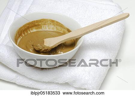 Stock Image - Healing earth, clay, red clay mixed with water. Fotosearch