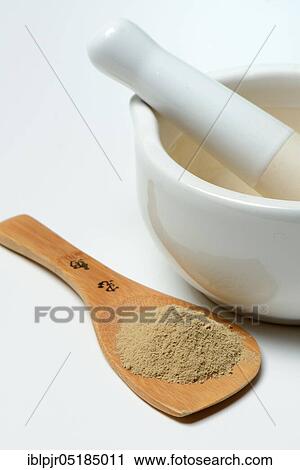 Stock Image - Healing earth powder with grating bowl, red clay. Fotosearch