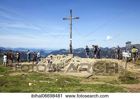 Hiker at the summit cross at Riedberger Horn, Grasgehren, near Obermaiselstein, Oberallgäu, Allgäu Alps, Allgäu, Bavaria, Germany, Europe View Large Photo Image Stock Image - Hiker at the summit cross at Riedberger Horn, Grasgehren, near Obermaiselstein, Oberallgäu, Allgäu Alps, Allgäu, Bavaria, Germany, Europe. Fotosearch