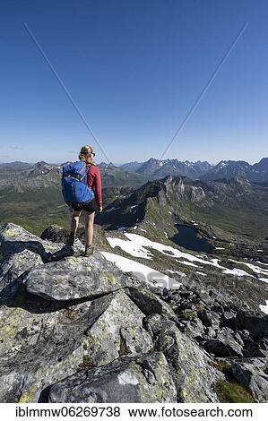 Hiker on the trail to the mountain Rundfjellet, Lofoten, Nordland, Norway, Europe View Large Photo Image Stock Photo - Hiker on the trail to the mountain Rundfjellet, Lofoten, Nordland, Norway, Europe. Fotosearch