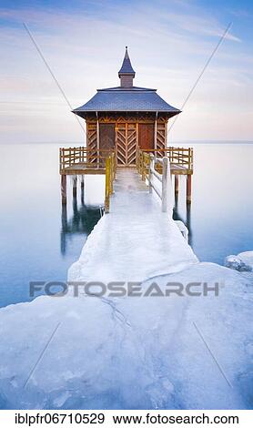 Stock Photo - Iced bathhouse at dusk, Lake Neuchâtel, Gorgier, Neuchâtel, Switzerland, Europe. Fotosearch