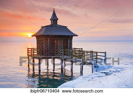 Picture - Iced bathhouse at sunrise, Lake Neuchâtel, Gorgier, Neuchâtel, Switzerland, Europe. Fotosearch