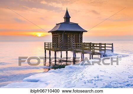 Iced wooden bathhouse at sunrise on Lake Neuchâtel in Gorgier, Neuchâtel, Switzerland, Europe View Large Photo Image Stock Image - Iced wooden bathhouse at sunrise on Lake Neuchâtel in Gorgier, Neuchâtel, Switzerland, Europe. Fotosearch