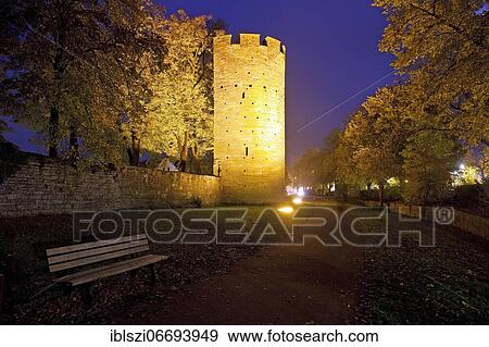 Illuminated Kattentor with city wall in the evening, Soest, North Rhine-Westphalia, Germany, Europe View Large Photo Image Stock Photo - Illuminated Kattentor with city wall in the evening, Soest, North Rhine-Westphalia, Germany, Europe. Fotosearch