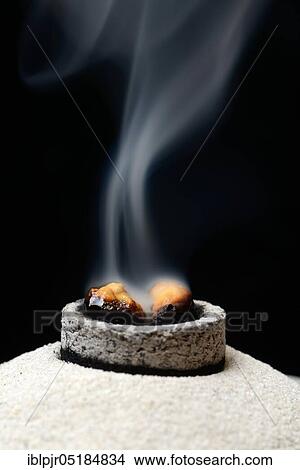 Picture - Incense is burned with the help of smoking coal, olibanum. Fotosearch