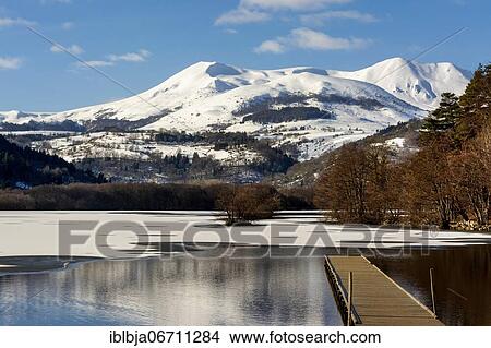 Picture - Lake Chambon in winter, Massif of Sancy in the background, Regional Nature Park of the Volcanoes of Auvergne, Puy de Dome department, Auvergne, France, Europe. Fotosearch