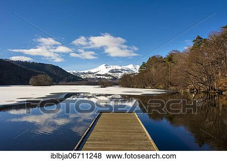 Lake Chambon in winter, Massif of Sancy in the background, Regional Nature Park of the Volcanoes of Auvergne, Puy de Dome department, Auvergne, France, Europe View Large Photo Image Stock Photo - Lake Chambon in winter, Massif of Sancy in the background, Regional Nature Park of the Volcanoes of Auvergne, Puy de Dome department, Auvergne, France, Europe. Fotosearch