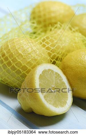 Lemons in a net, cut open, halved ( Citrus limon) View Large Photo Image Picture - Lemons in a net, cut open, halved ( Citrus limon). Fotosearch
