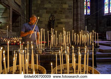 Man lighting a votive candle, devotional candles, Notre Dame Church, Saint-Jean-Pied-de-Port, Camino de Santiago, Via Podiensis, Camino Francés, Pyrenees, Département Pyrénées-Atlantiques. Region Nouvelle-Aquitaine, Pays Basque, Basque Country,... View Large Photo Image Stock Photo - Man lighting a votive candle, devotional candles, Notre Dame Church, Saint-Jean-Pied-de-Port, Camino de Santiago, Via Podiensis, Camino Francés, Pyrenees, Département Pyrénées-Atlantiques. Region Nouvelle-Aquitaine, Pays Basque, Basque Country,.... Fotosearch