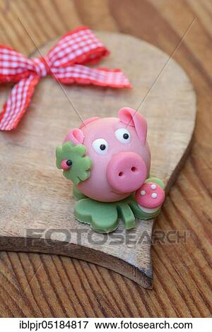 Marzipan lucky pig on a wooden heart, Marzipan pig View Large Photo Image Stock Photo - Marzipan lucky pig on a wooden heart, Marzipan pig. Fotosearch