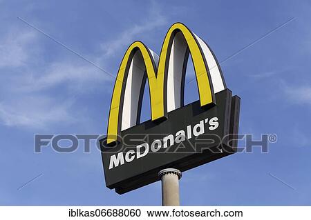 Stock Image - McDonald's, logo in front of blue sky, Düsseldorf, North Rhine-Westphalia, Germany, Europe. Fotosearch