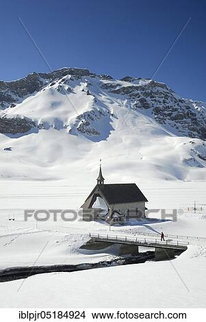 Picture - Melchsee-Frutt, chapel and frozen Melchsee, skiing area in the Swiss Alps, Canton Obwalden, Switzerland, Europe. Fotosearch