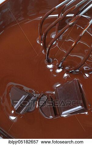 Stock Photo - Melted dark chocolate, cake glaze, couverture, couverture, whisk. Fotosearch