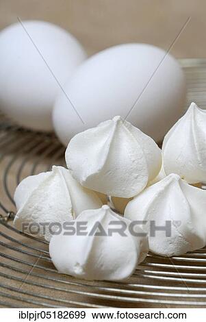 Stock Photo - Meringues and hen's eggs, meringue, meringue pastry, meringue foam, meringue, meringue, hen's eggs, hen's egg. Fotosearch