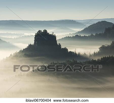 Morning atmosphere in the Elbe Sandstone Mountains, view of the Hintere Raubschloß or Winterstein, fog in the valley, Saxon Switzerland National Park, Saxony, Germany, Europe View Large Photo Image Picture - Morning atmosphere in the Elbe Sandstone Mountains, view of the Hintere Raubschloß or Winterstein, fog in the valley, Saxon Switzerland National Park, Saxony, Germany, Europe. Fotosearch