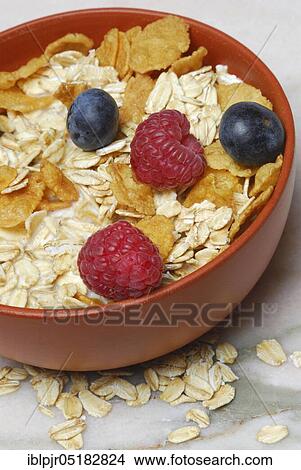 Picture - Muesli, cornflakes, oat flakes and berries, raspberries, blueberries, oats. Fotosearch