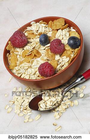Stock Photography - Muesli, cornflakes, oat flakes and berries, raspberries, blueberries, oats. Fotosearch
