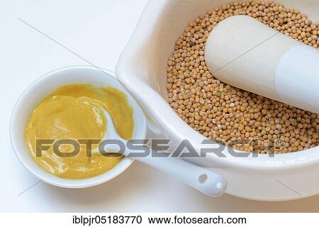 Stock Image - Mustard seed, yellow, in grating bowl, bowl with mustard, mustard seeds, mustard, mustard, table mustard, prepare mustard, mortar. Fotosearch