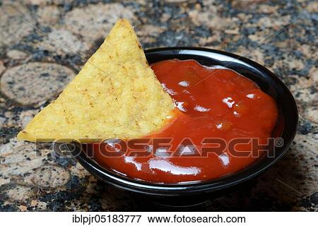 Stock Photo - Nachos with tomato dip, snack, starter, chip, chips, salsa, dip sauce, dip sauce, corn chips. Fotosearch